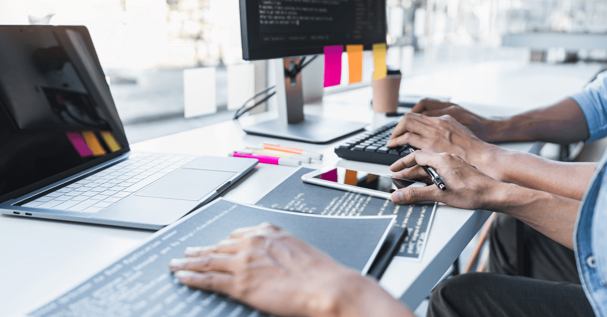 Computer coders at work, working on how to increase PPC and Meta Advertising power with quantum computing.