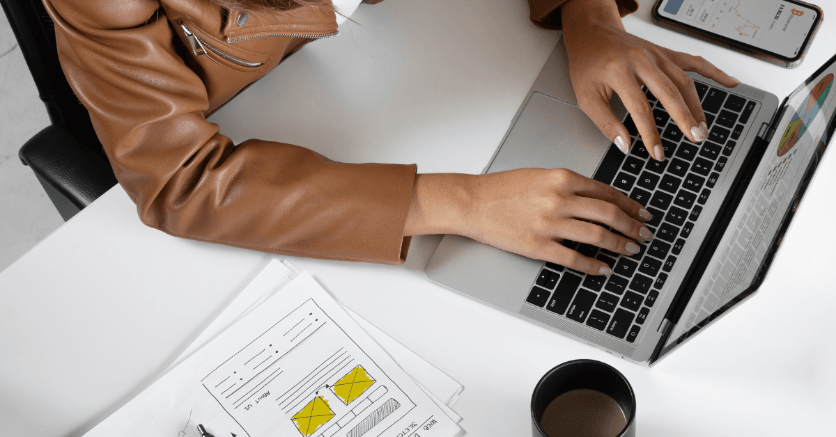 Woman works on laptop, calculating the impact of increasing her digital ad budget.