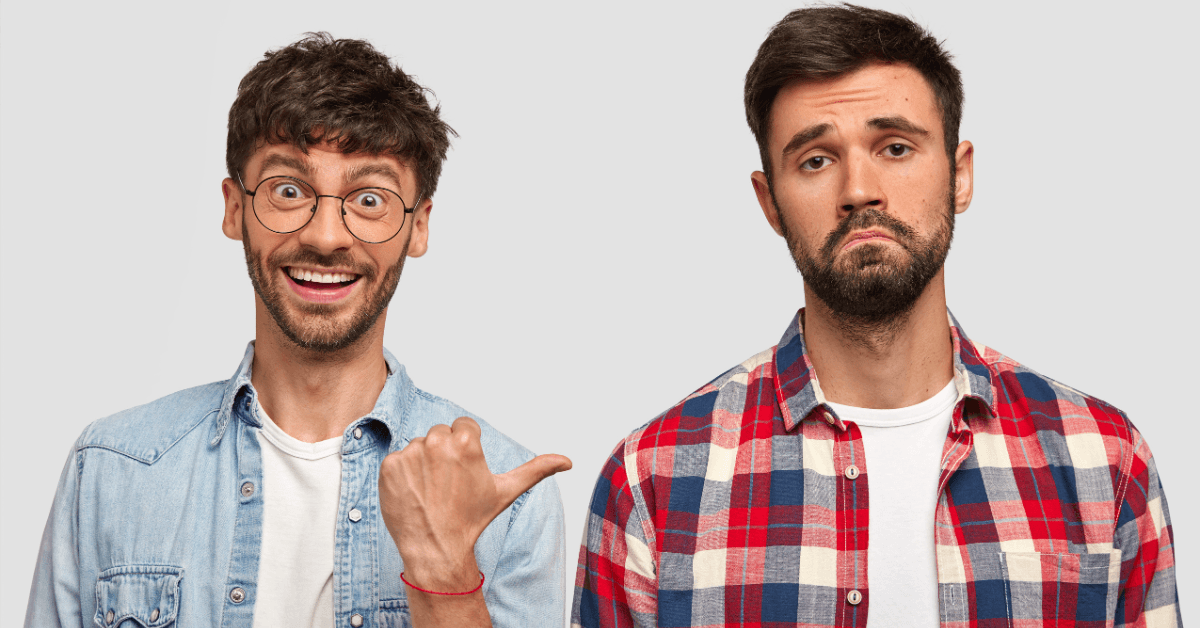 A happy man in glasses and a denim shirt points to a frowning man in a plaid shirt, demonstrating the difference between a business that has a crisis-proof digital marketing strategy during economic shifts and one that does not.