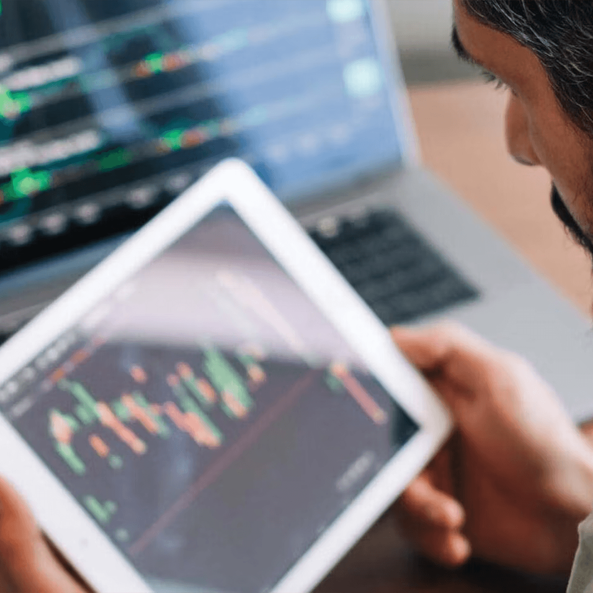 A man looking at a marketing analytics and reporting graph on a laptop.