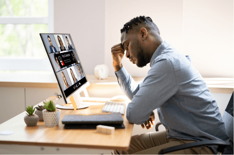 A man in his office, frowning at his computer screen, irritated, wondering "why is my website so slow?"
